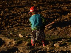 15 Child In Colourful Clothing Tilling The Field At Sunset In Yilik Village On The Way To K2 China Trek.jpg
